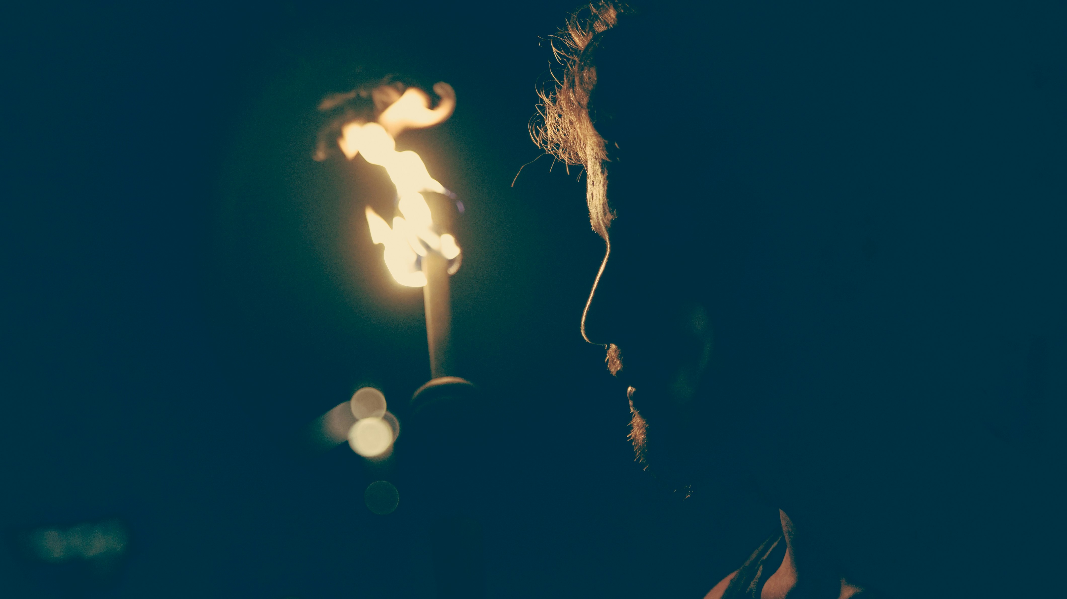 man standing in front of candle